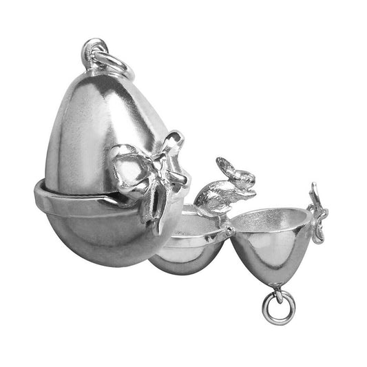 Sterling silver Easter egg charm with rabbit inside on a white background