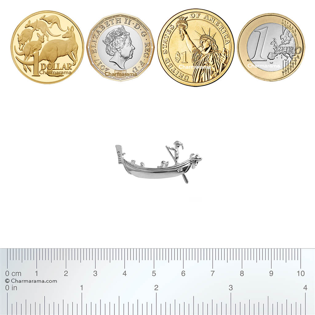 Sterling silver gondola charm with coins and ruler for scale on a white background