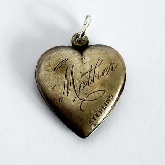 Heart-shaped sterling silver pendant with 'Mother' engraving on a white background