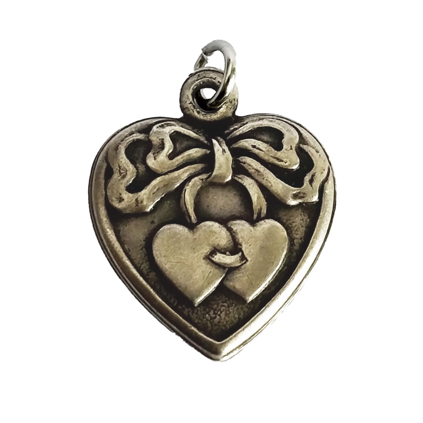 Silver heart-shaped pendant with bow and heart design on a white background