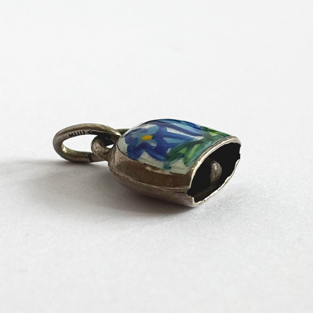 Vintage Silver Swiss Bell Charm with blue gentian flower on a white background