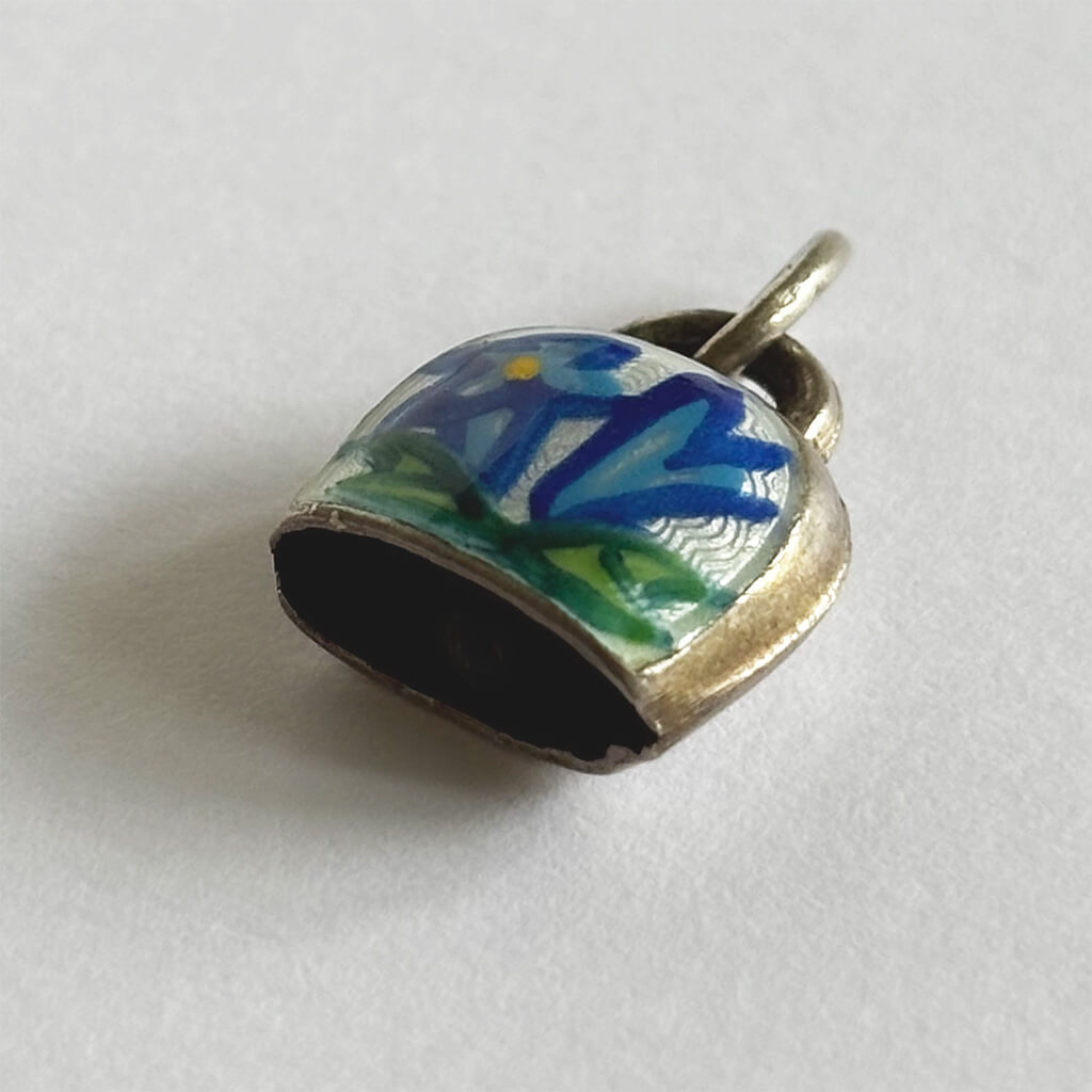 Vintage Silver Swiss Bell Charm with blue gentian flower on a white background