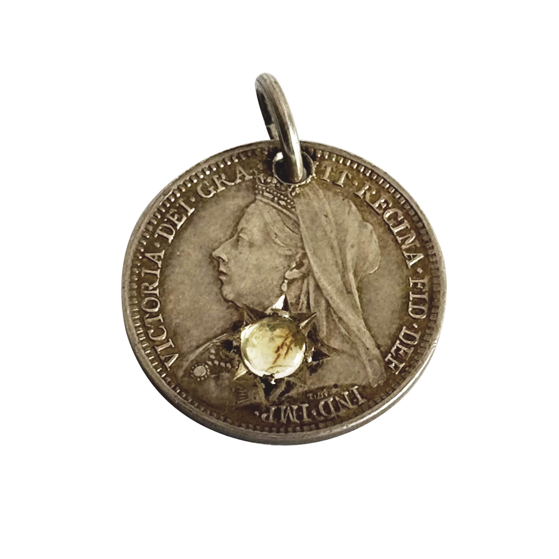 Coin with a profile of a queen and a yellow gemstone on a white background