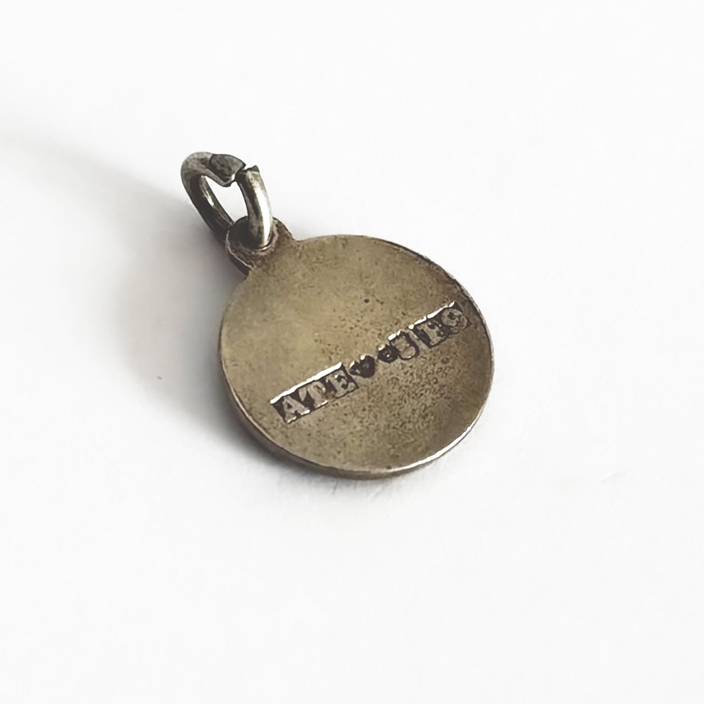Back of a round silver charm with full Swedish hallmarks