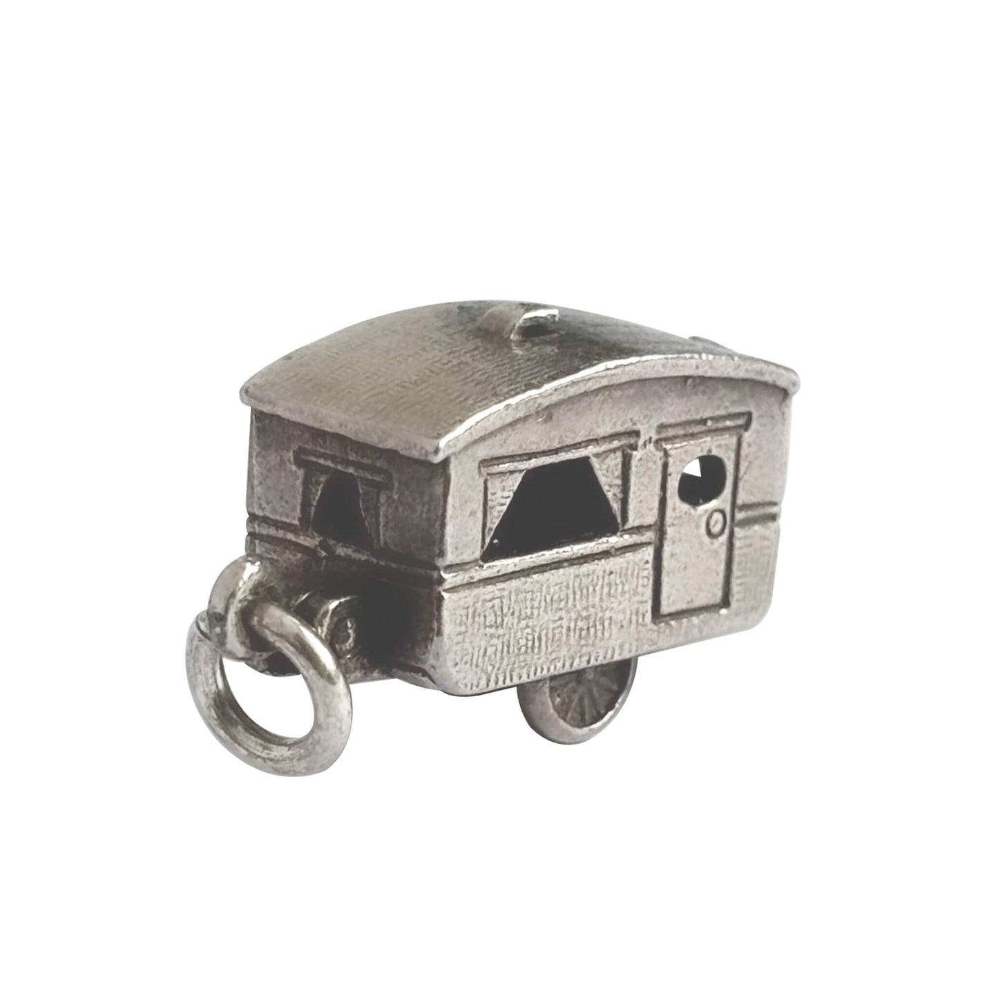 Vintage silver opening caravan charm on a white background.