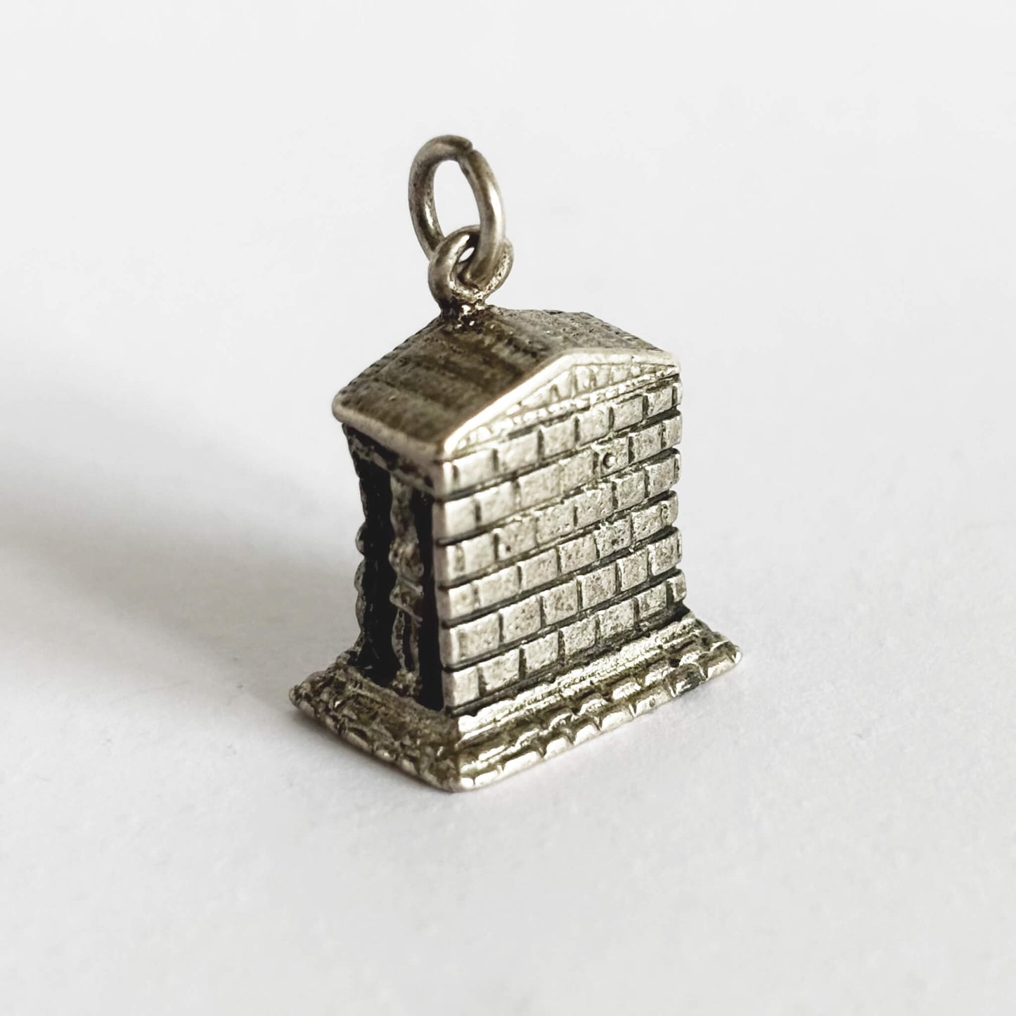 Silver temple charm on a white background