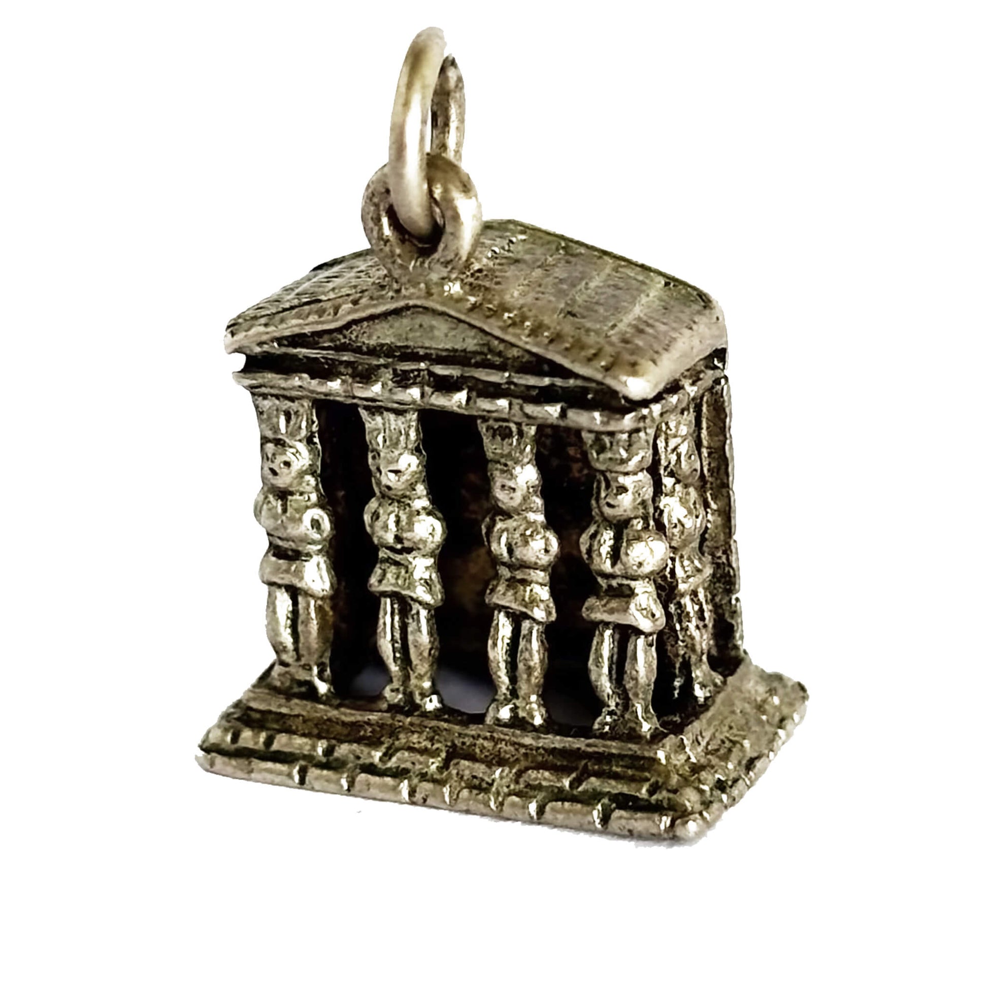 Silver temple charm with figures on a white background