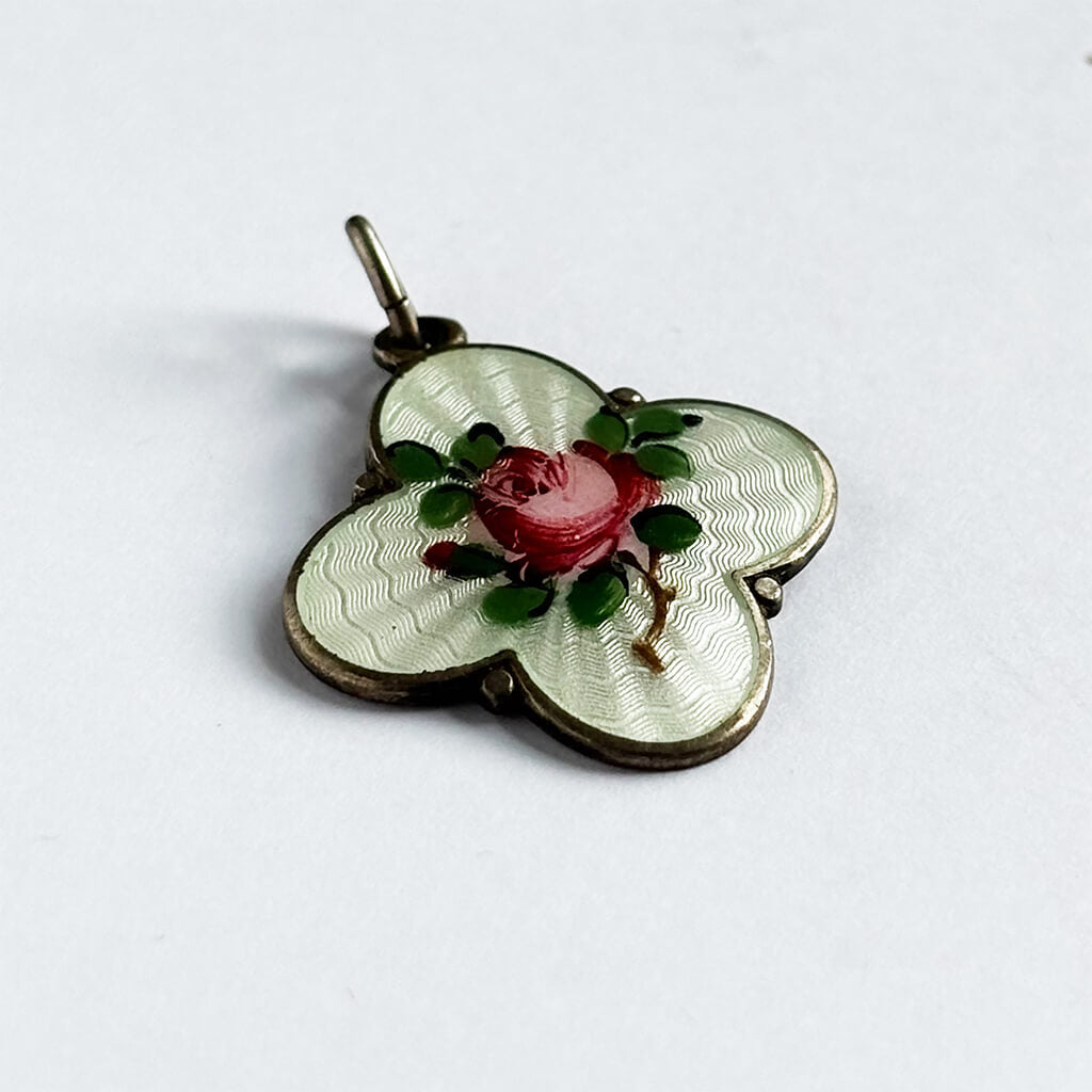 Vintage quatrefoil pendant with a rose design on a white background by David Andersen