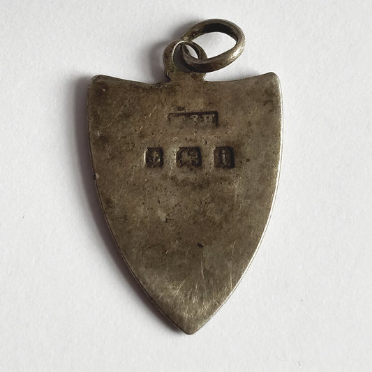 Antique shield charm reverse with 1908 Birmingham hallmarks on white background