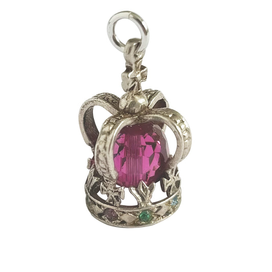 Silver crown pendant with a pink gemstone on a white background