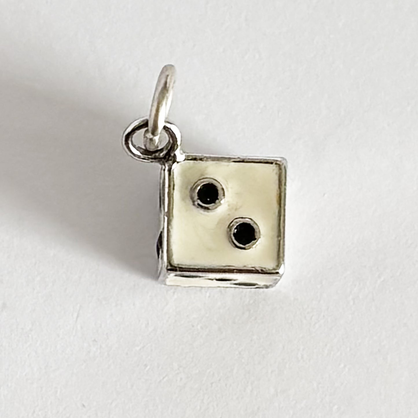 Vintage die charm in sterling silver white enamel with black dots