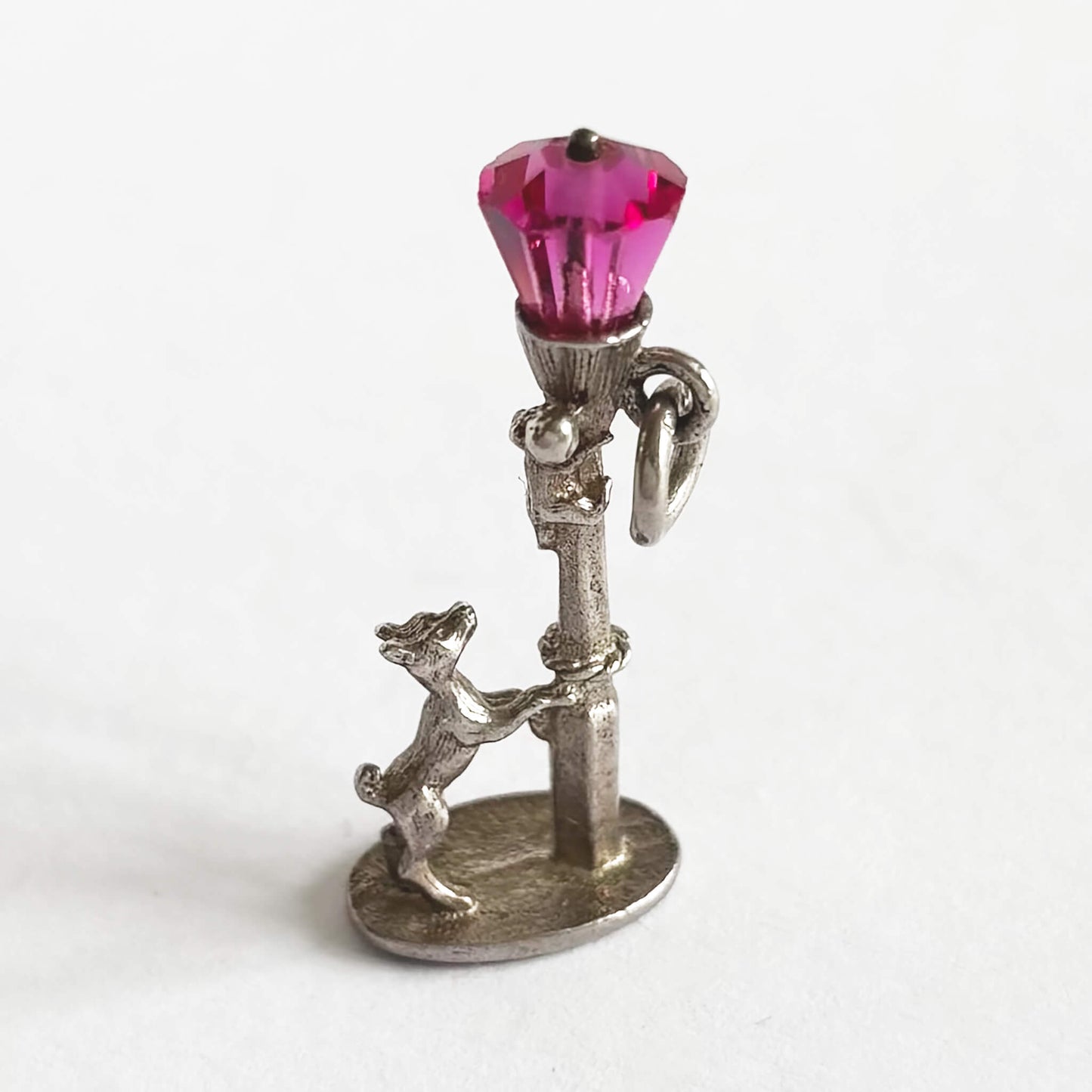 Dog chasing cat up lamppost charm with pink crystal