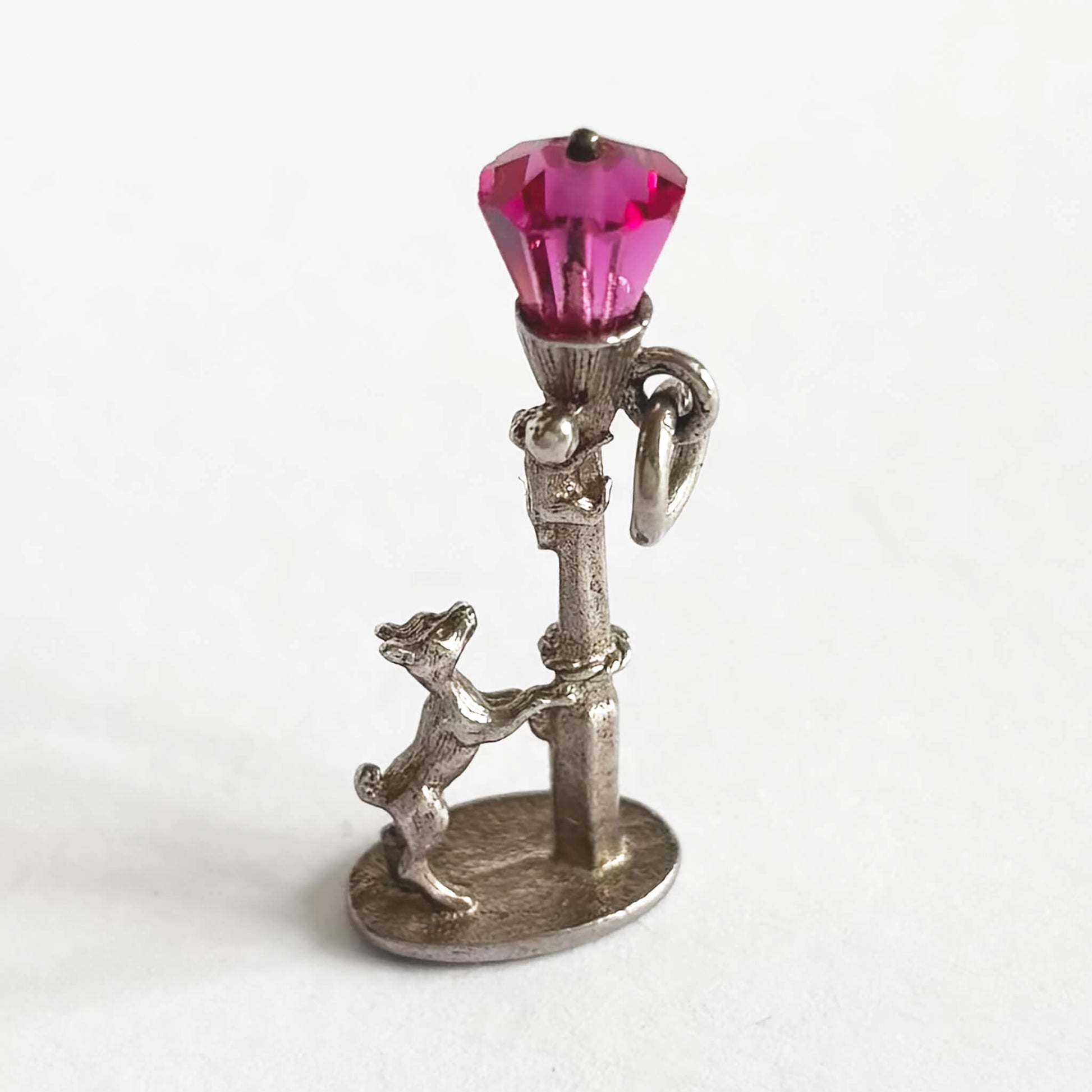 Dog chasing cat up lamppost charm with pink crystal