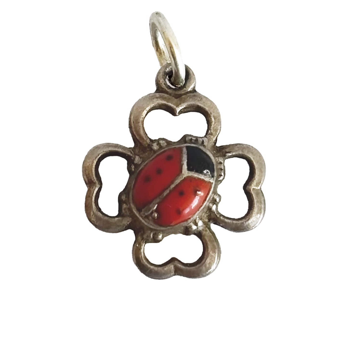 Silver pendant with a red ladybug design on a white background