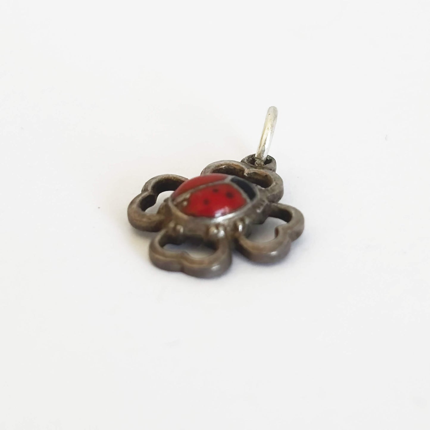 Pendant with a red and black design on a white background