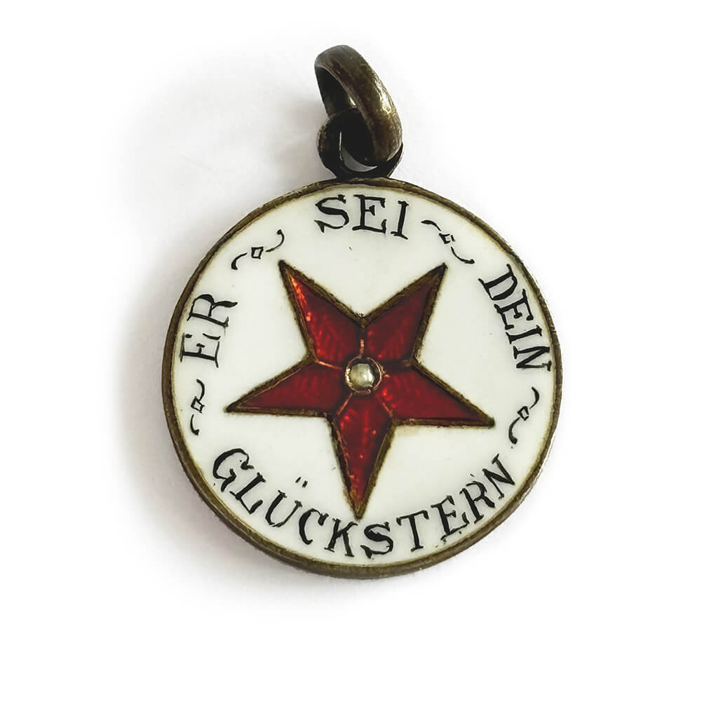 Pendant with red star and German text on a white background