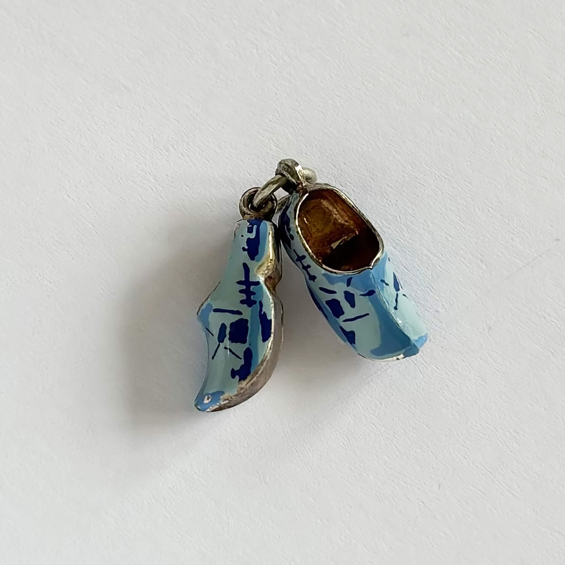 A pair of blue Dutch clogs pendant on a white background