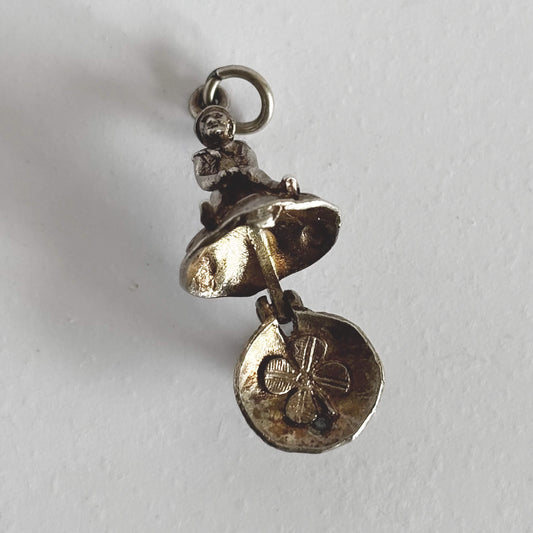 Silver leprechaun on toadstool charm open to four leaf clover on a white background