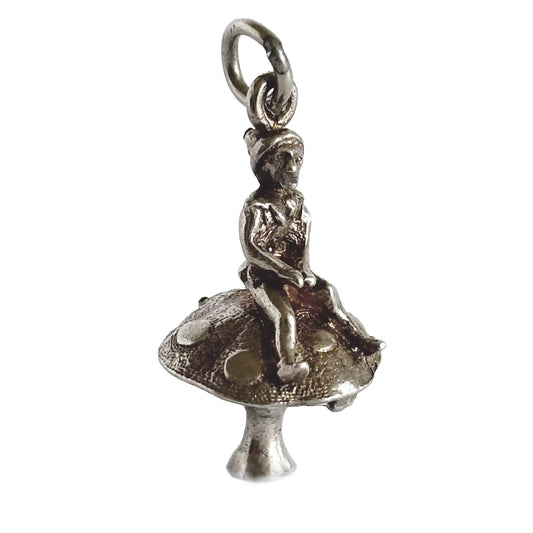 Silver leprechaun on toadstool charm on a white background