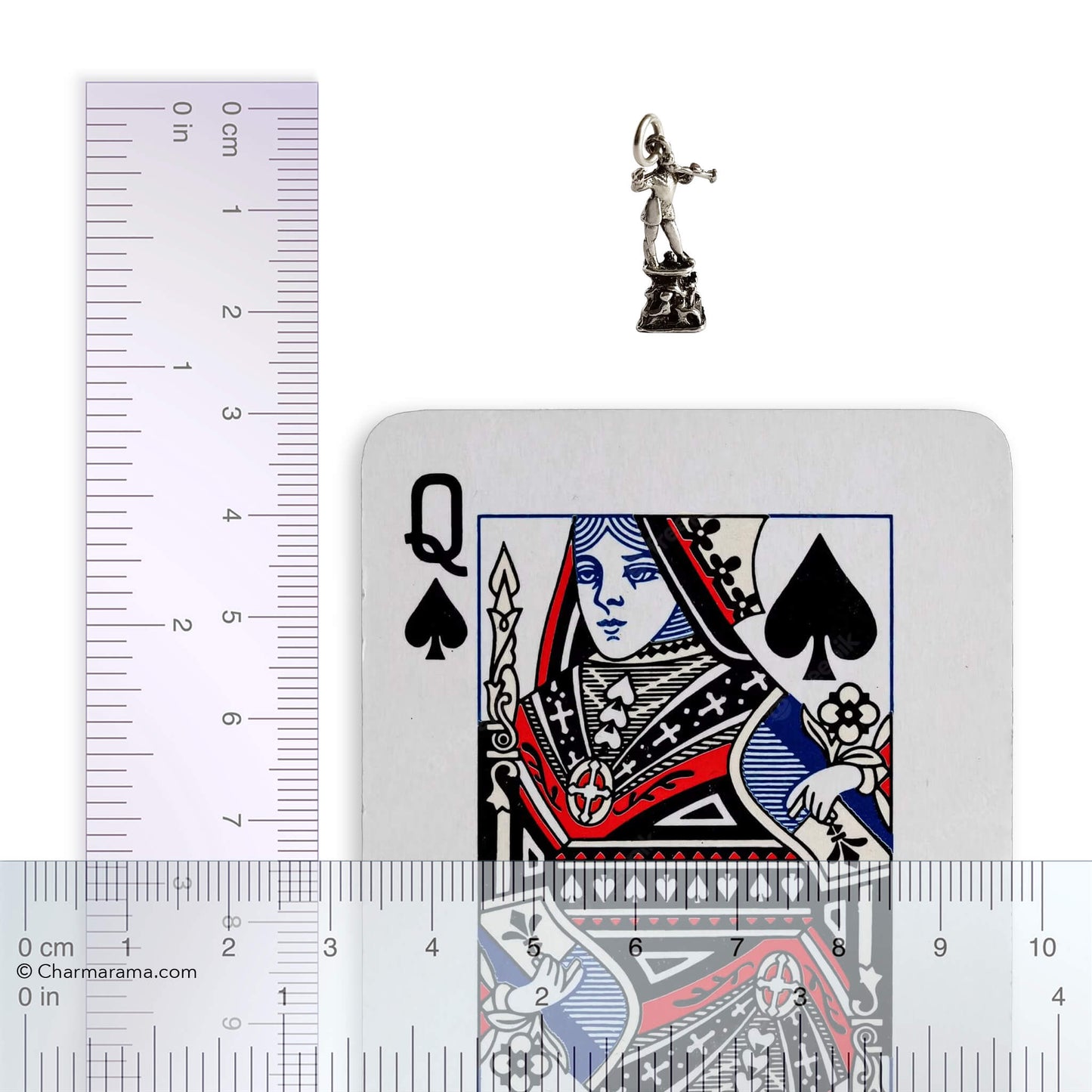 Playing card with Queen of Spades design, silver charm, and ruler for scale on a white background
