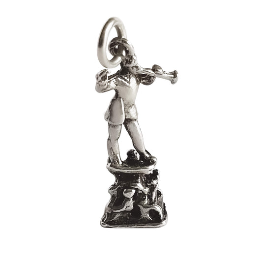Silver pied piper charm on a white background