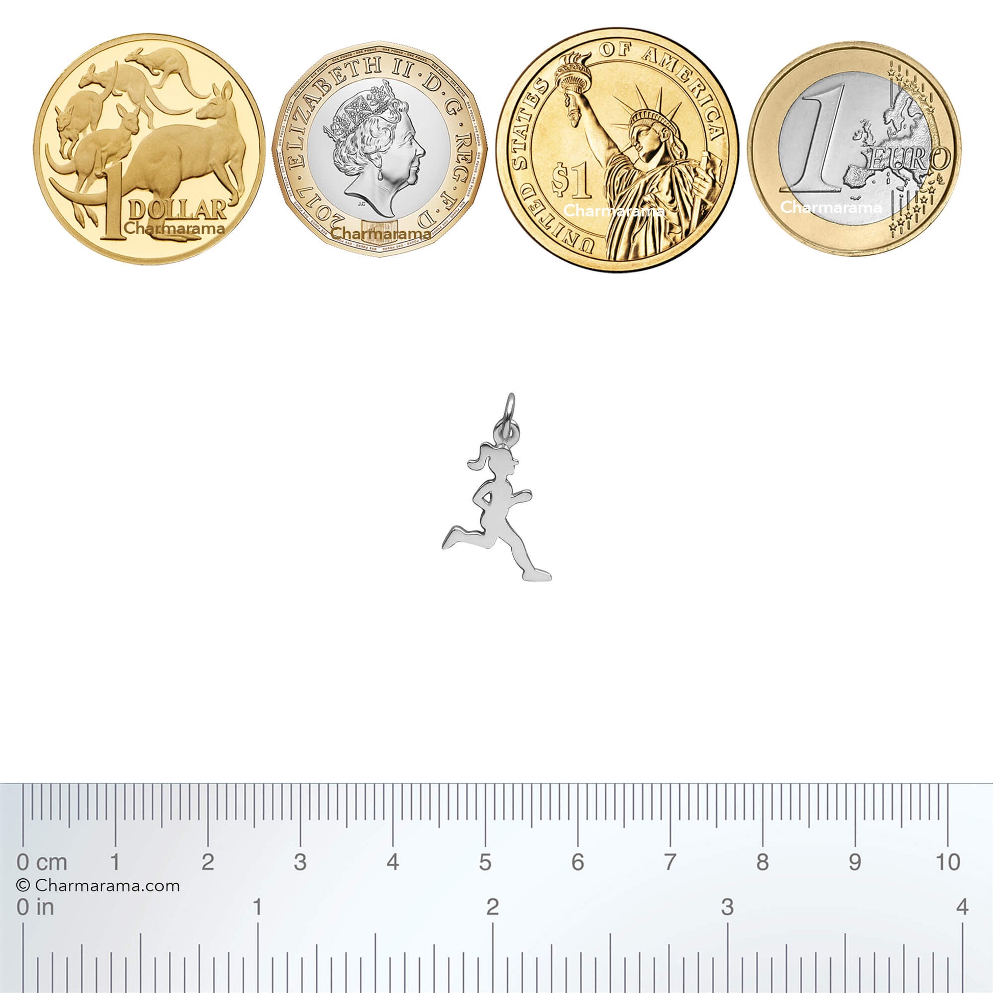 Silver running girl charm next to coins with a ruler for scale on a white background