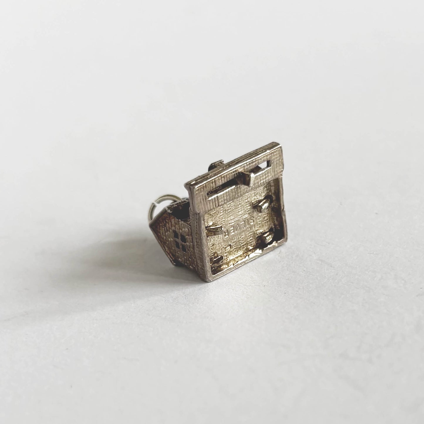 A vintage silver train in station charm on a white background
