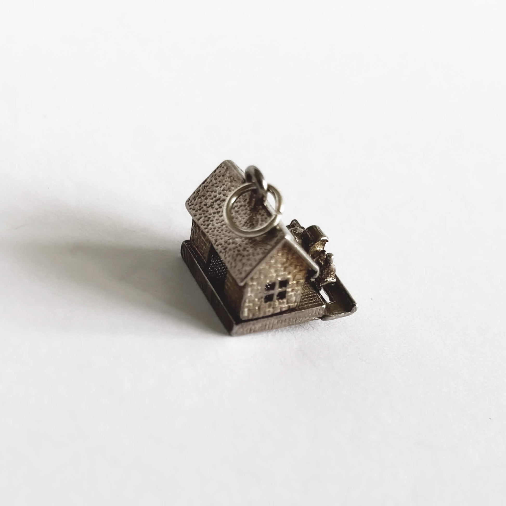 A vintage silver train in station charm on a white background
