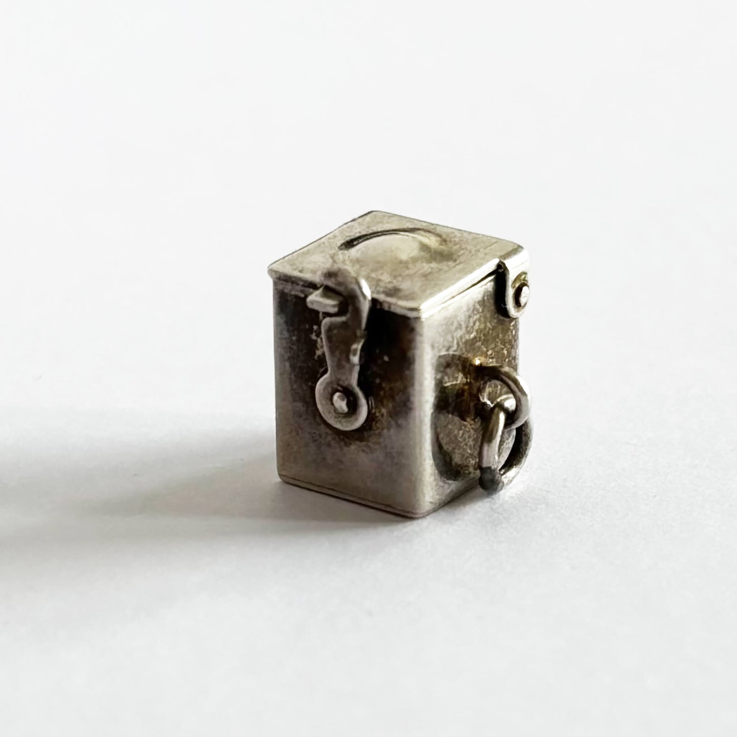 Vintage sterling silver Jack-in-the-box charm, closed, on white background