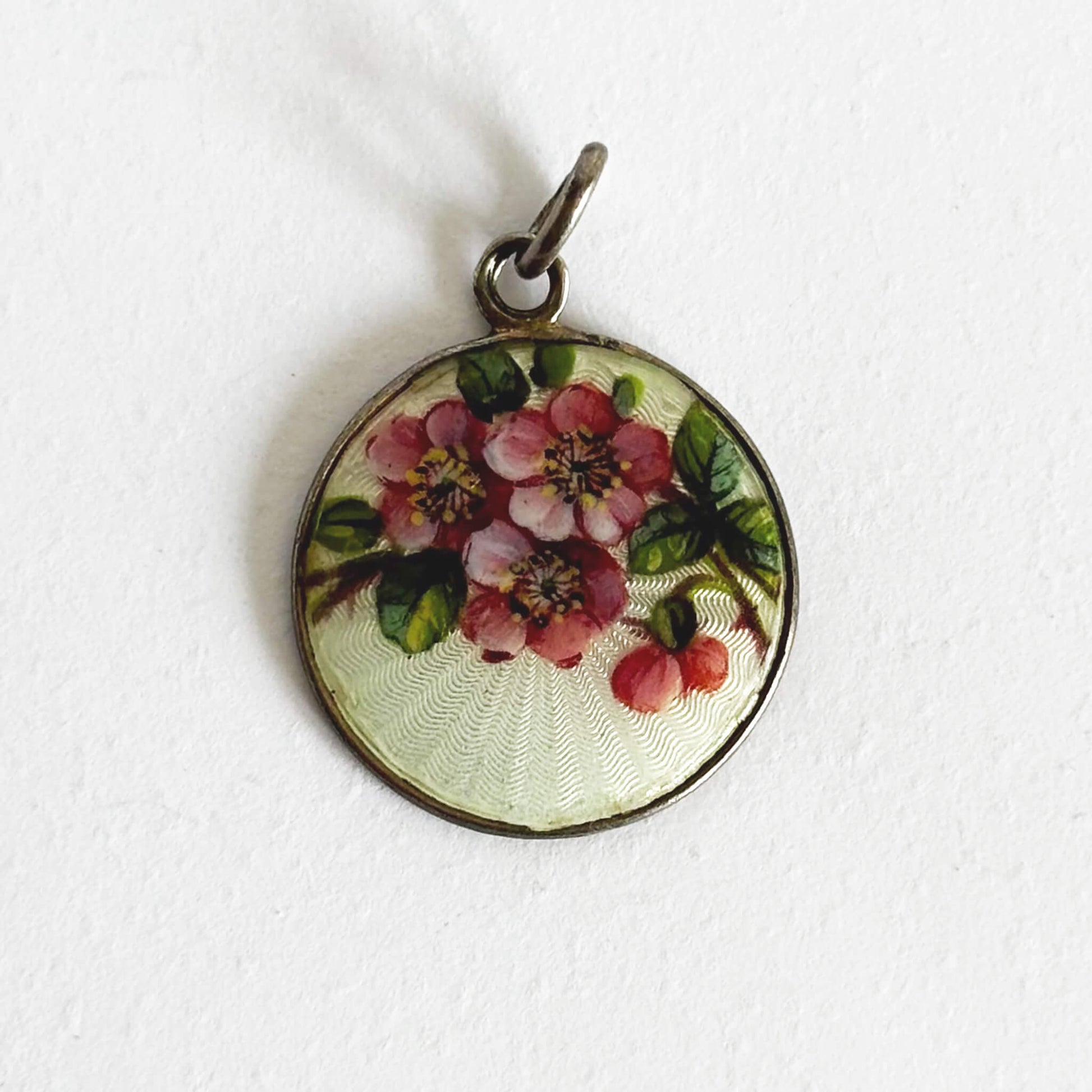Round floral pendant on a white background