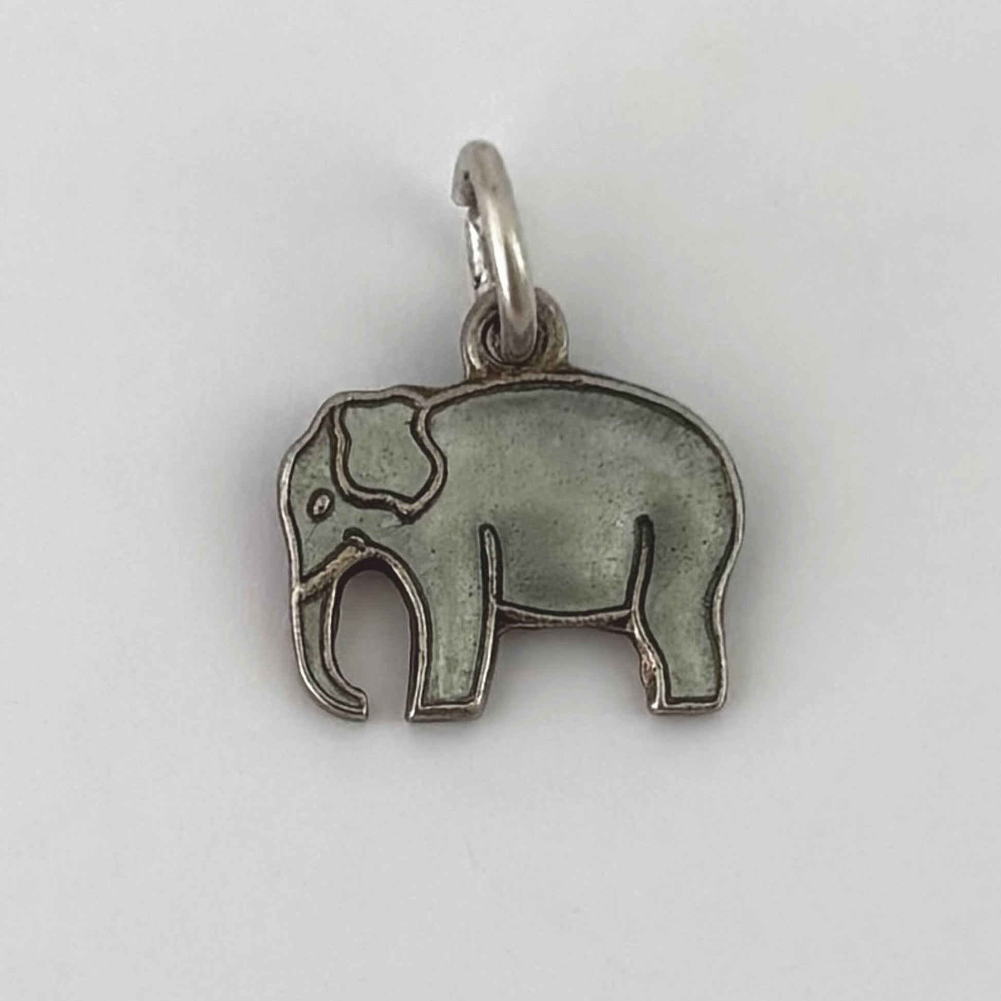 Silver elephant pendant on a white background