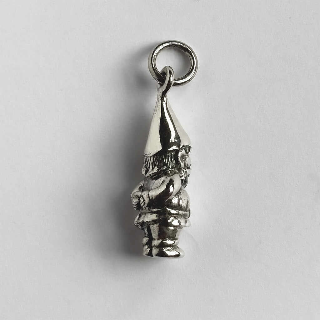 Silver gnome charm on a light gray background
