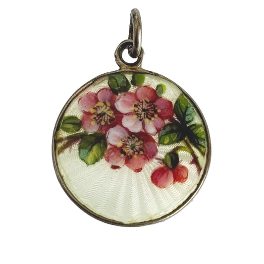 Round floral pendant with pink flowers on a white background