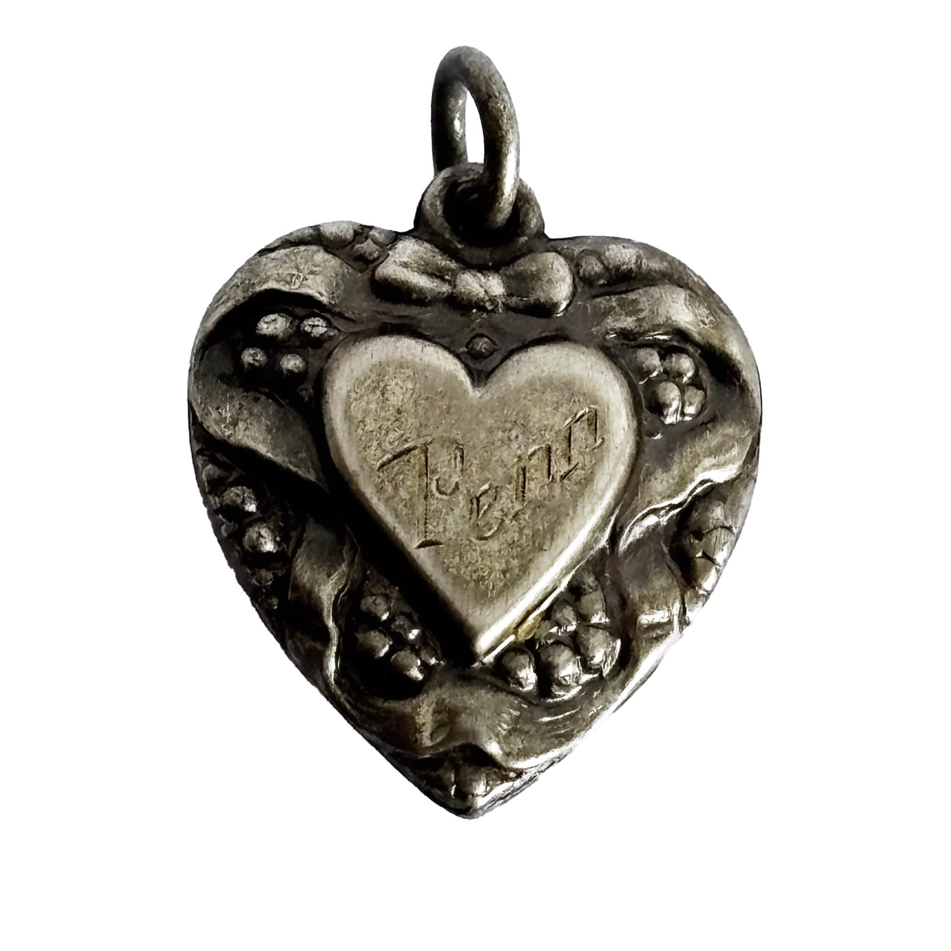 Silver heart-shaped pendant with engraved name on a white background