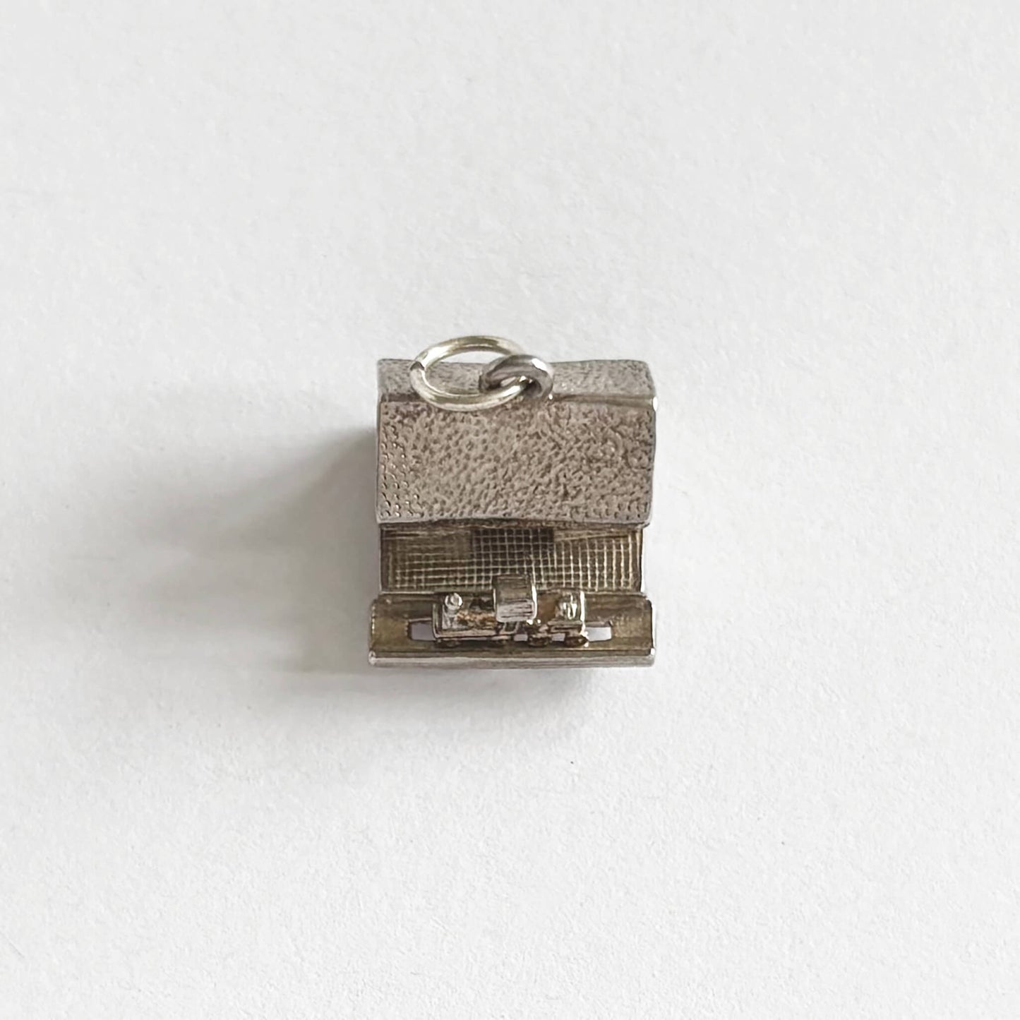 A vintage silver train in station charm on a white background