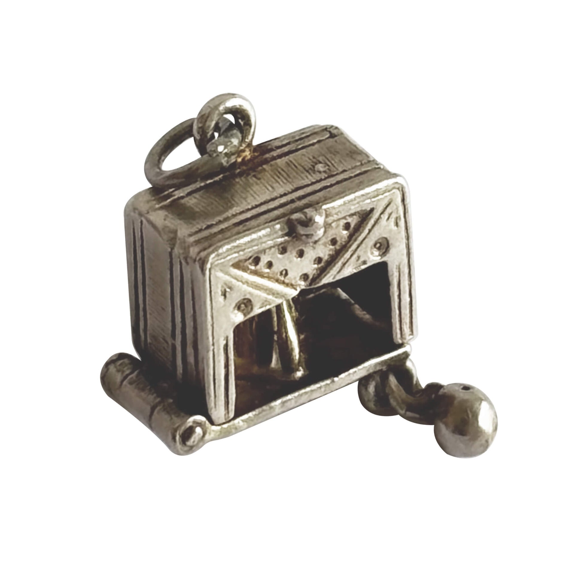 A rare vintage silver bowling alley charm with ball and skittles inside, made by Nuvo, on a white background