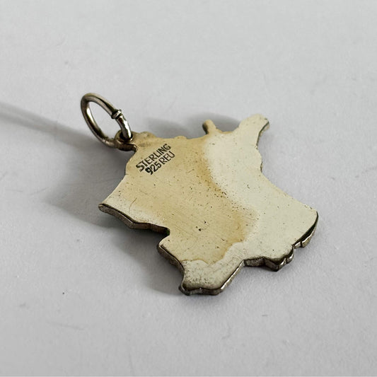 Back of a France map charm on light grey background