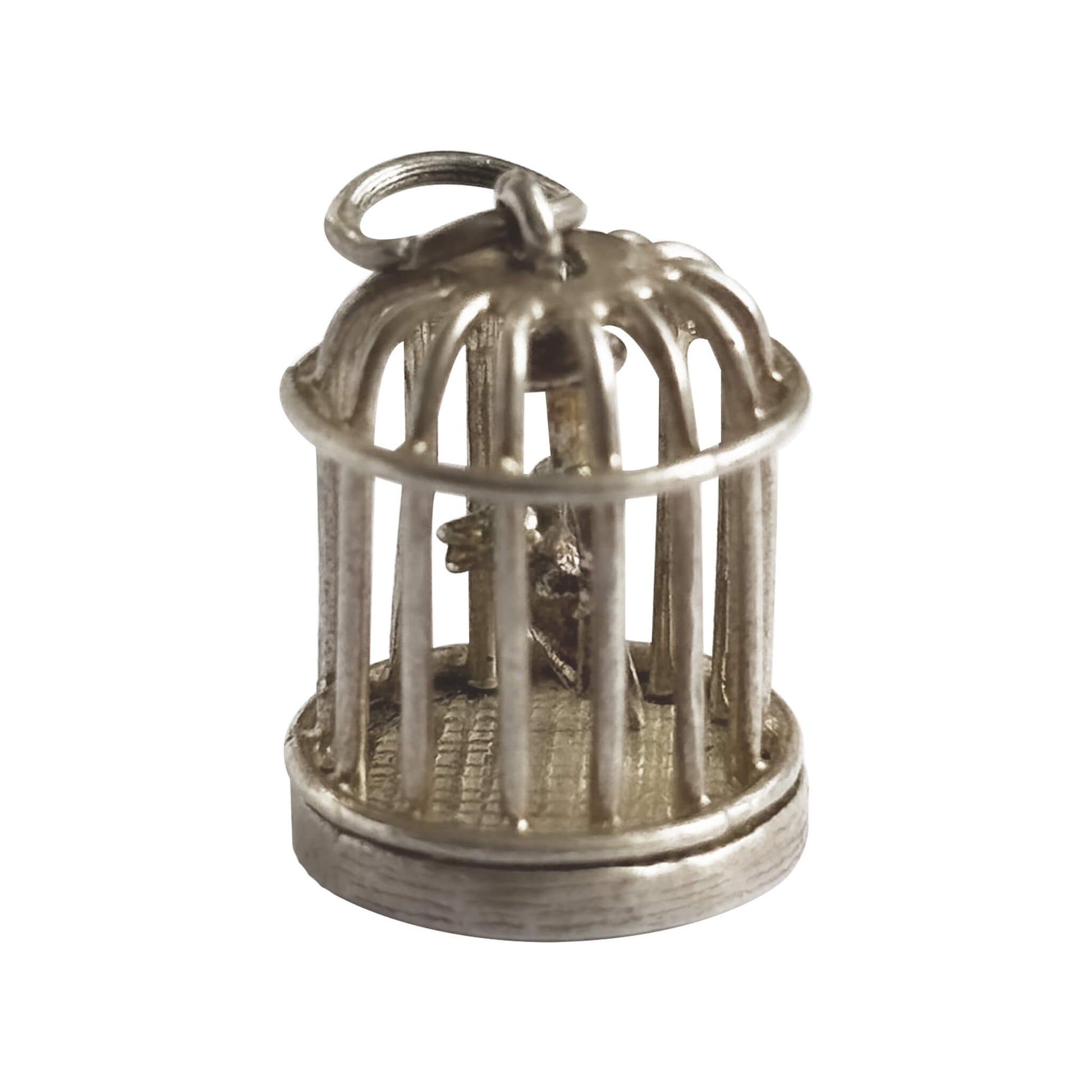 Vintage silver bird in a cage charm on a white background.