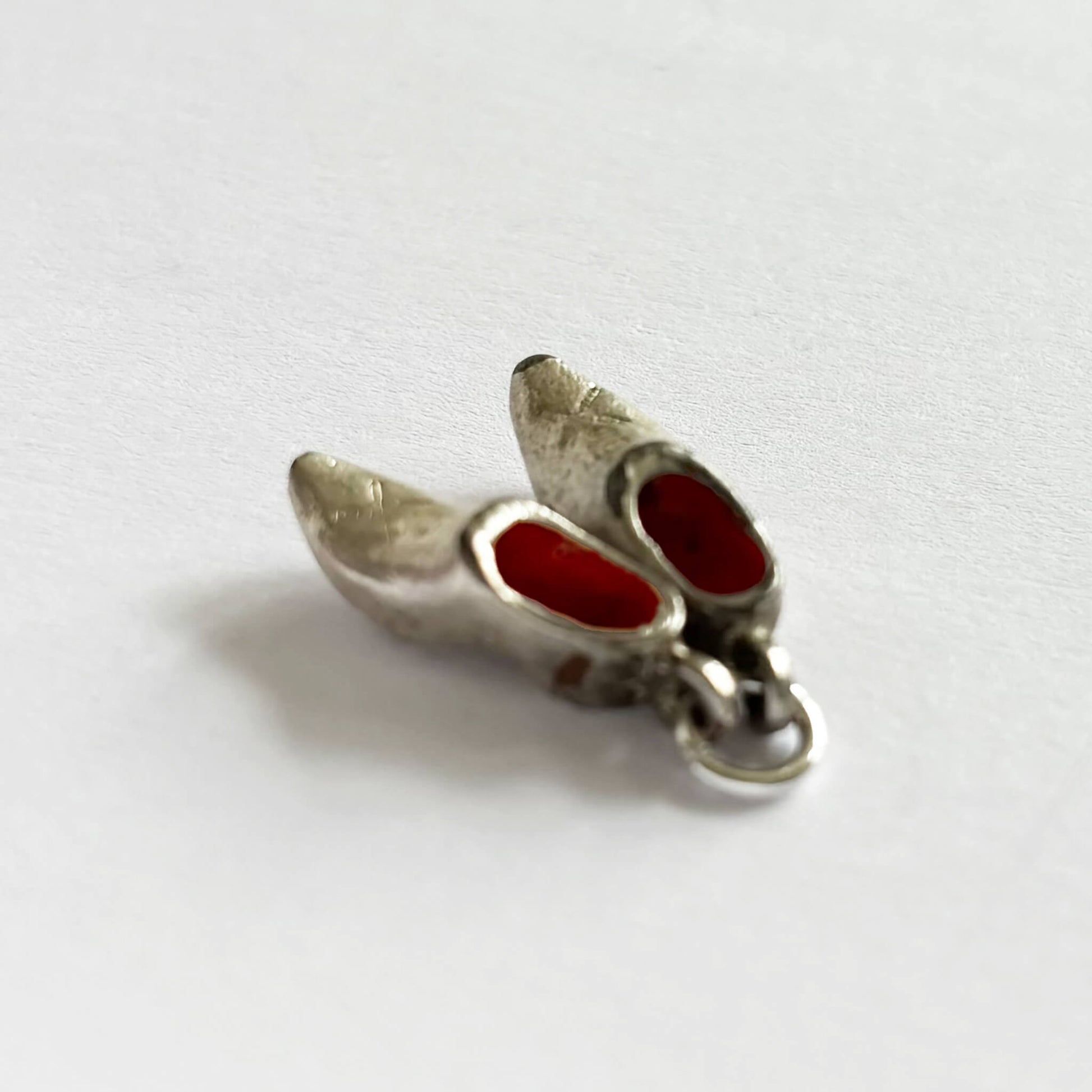 A pair of 1960s silver plated and red enamel Dutch clogs charm.