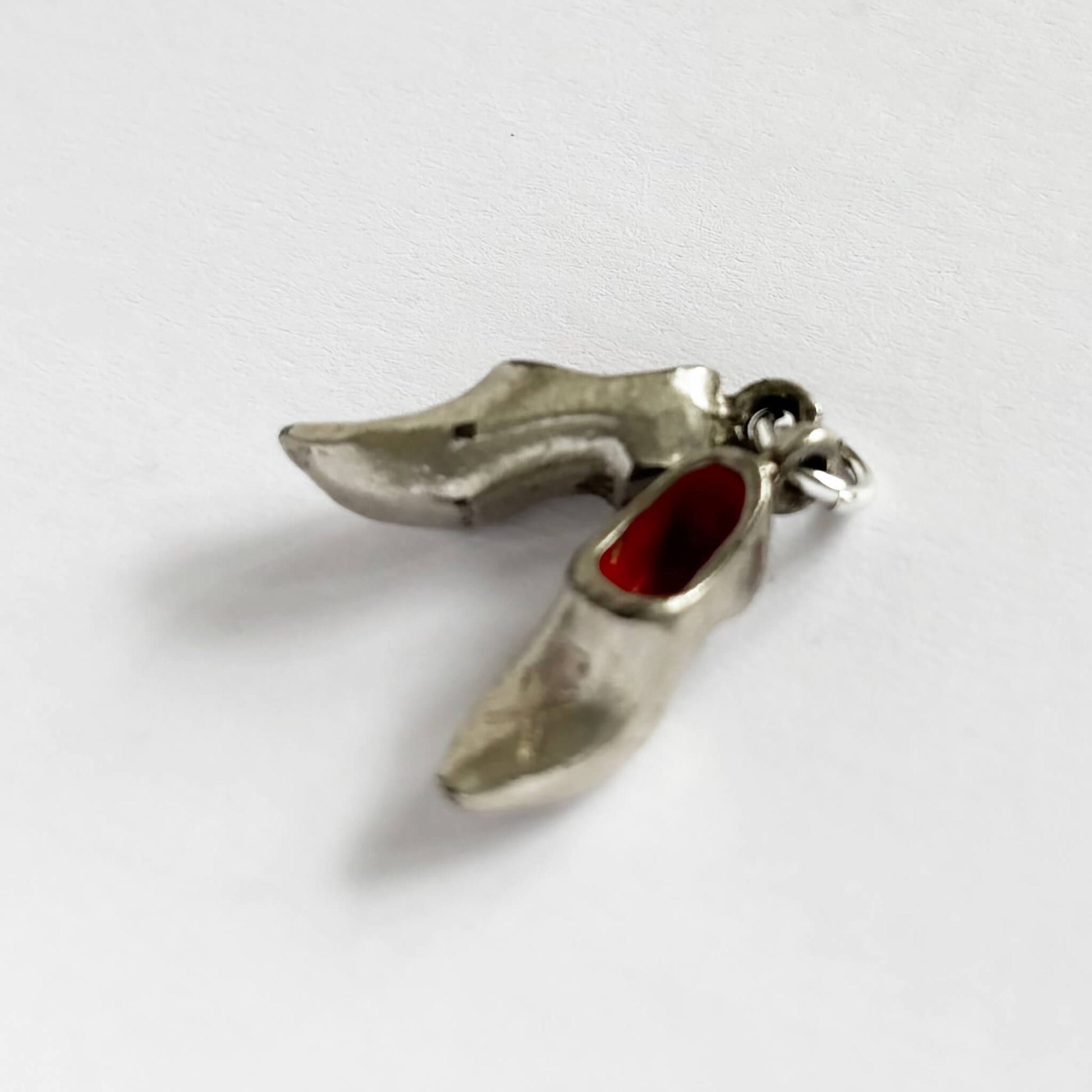 A pair of shoes charm silver plated and red enamel Dutch clogs.