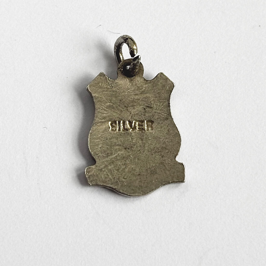 Silver pendant with 'SILVER' engraving on a white background