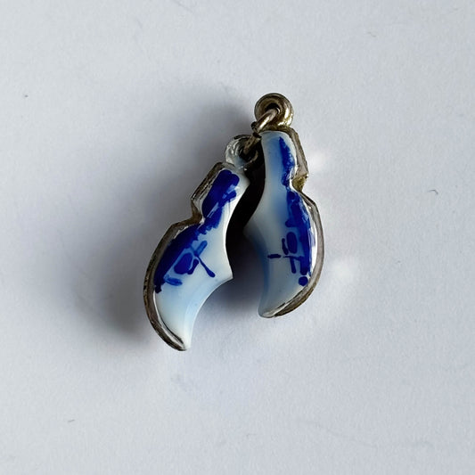 Silver Dutch clogs charm with blue enamel on white background