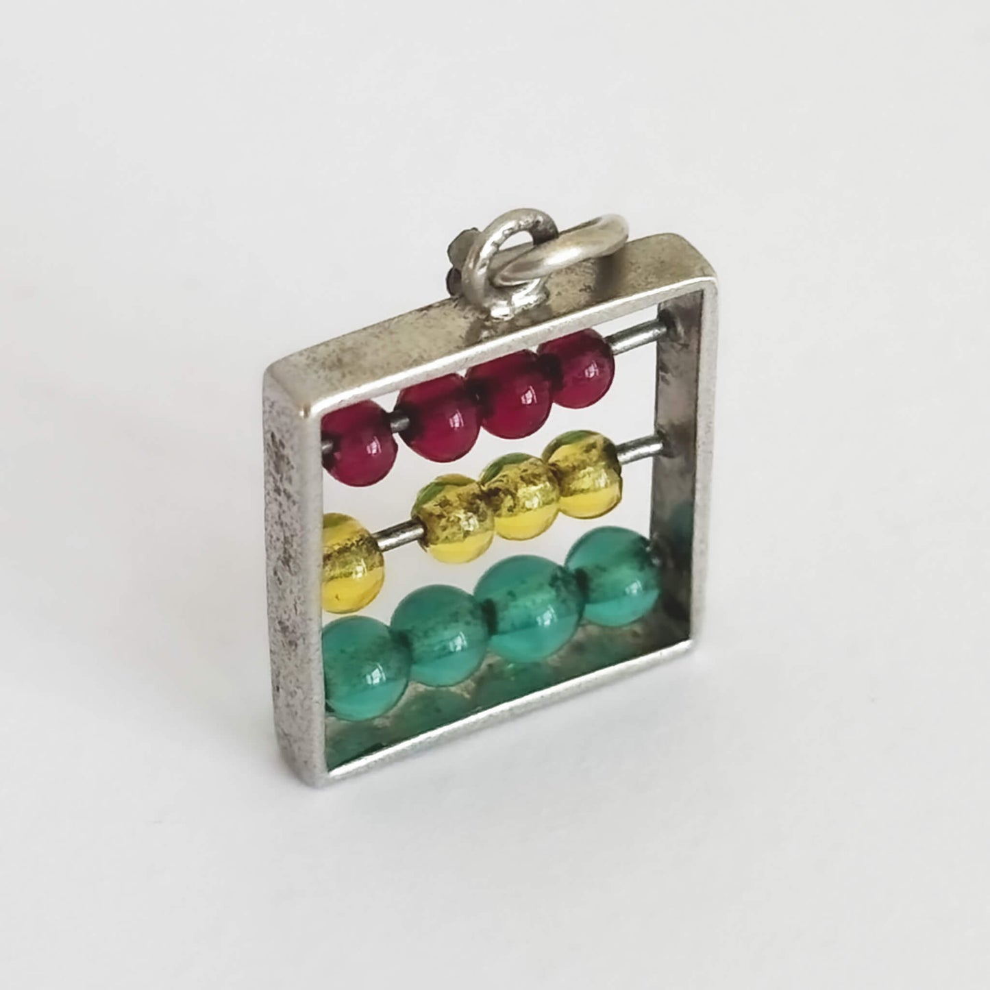 Abacus pendant with colourful counters on a white background