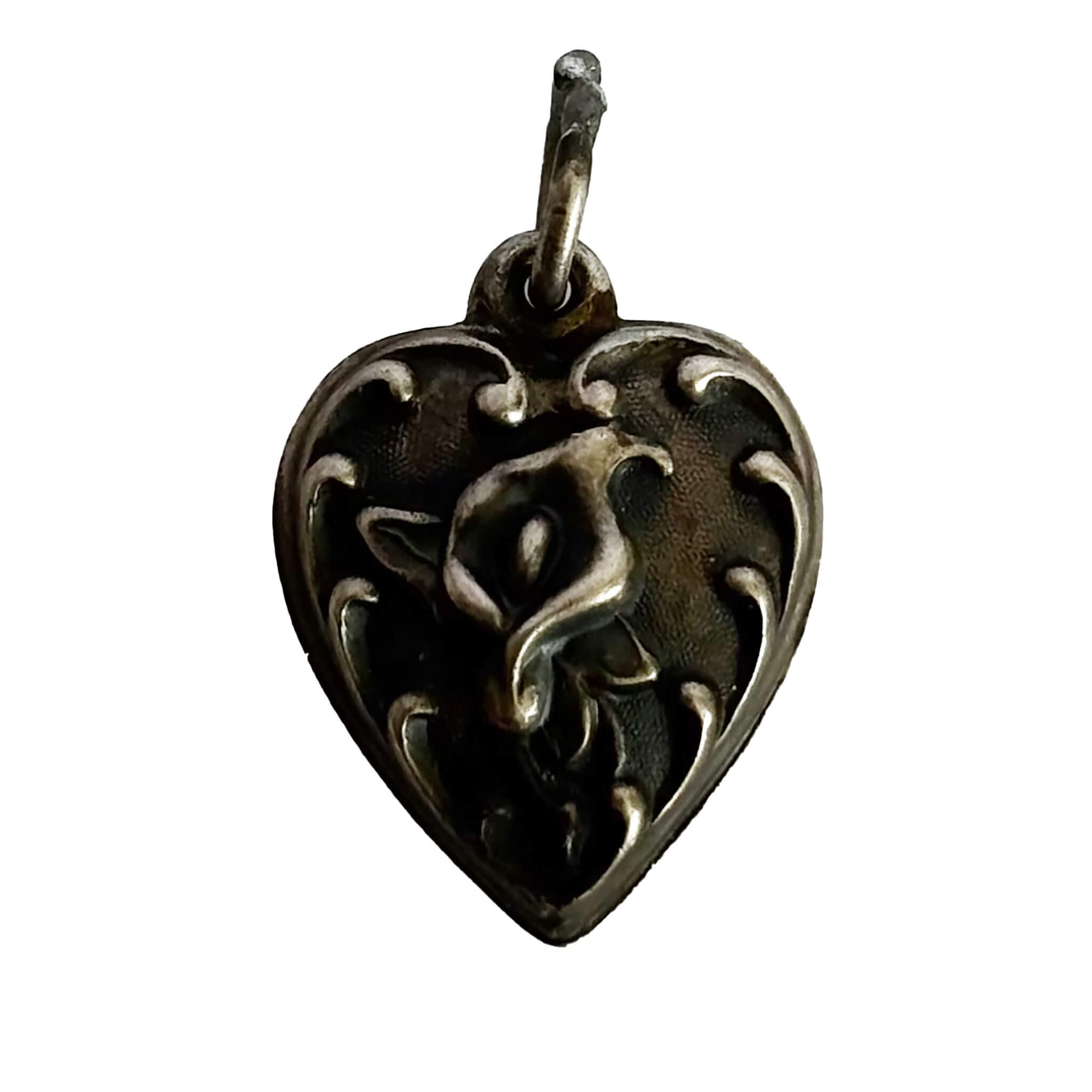 Heart-shaped pendant with intricate calla lily flower design on a white background