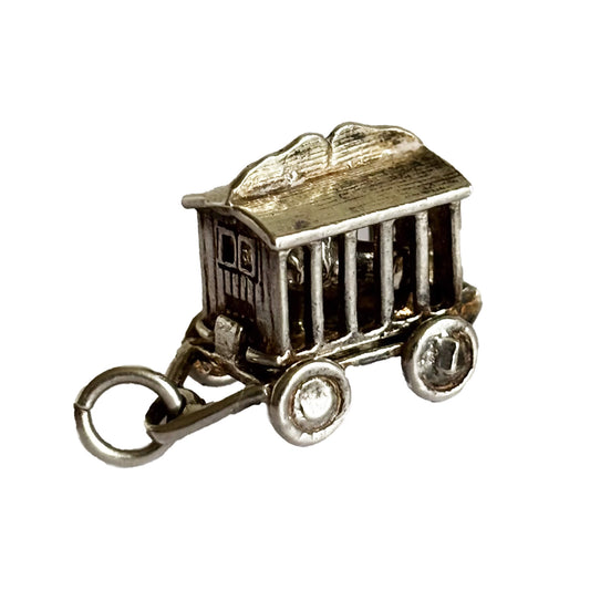 silver circus wagon charm with lion inside on a white background