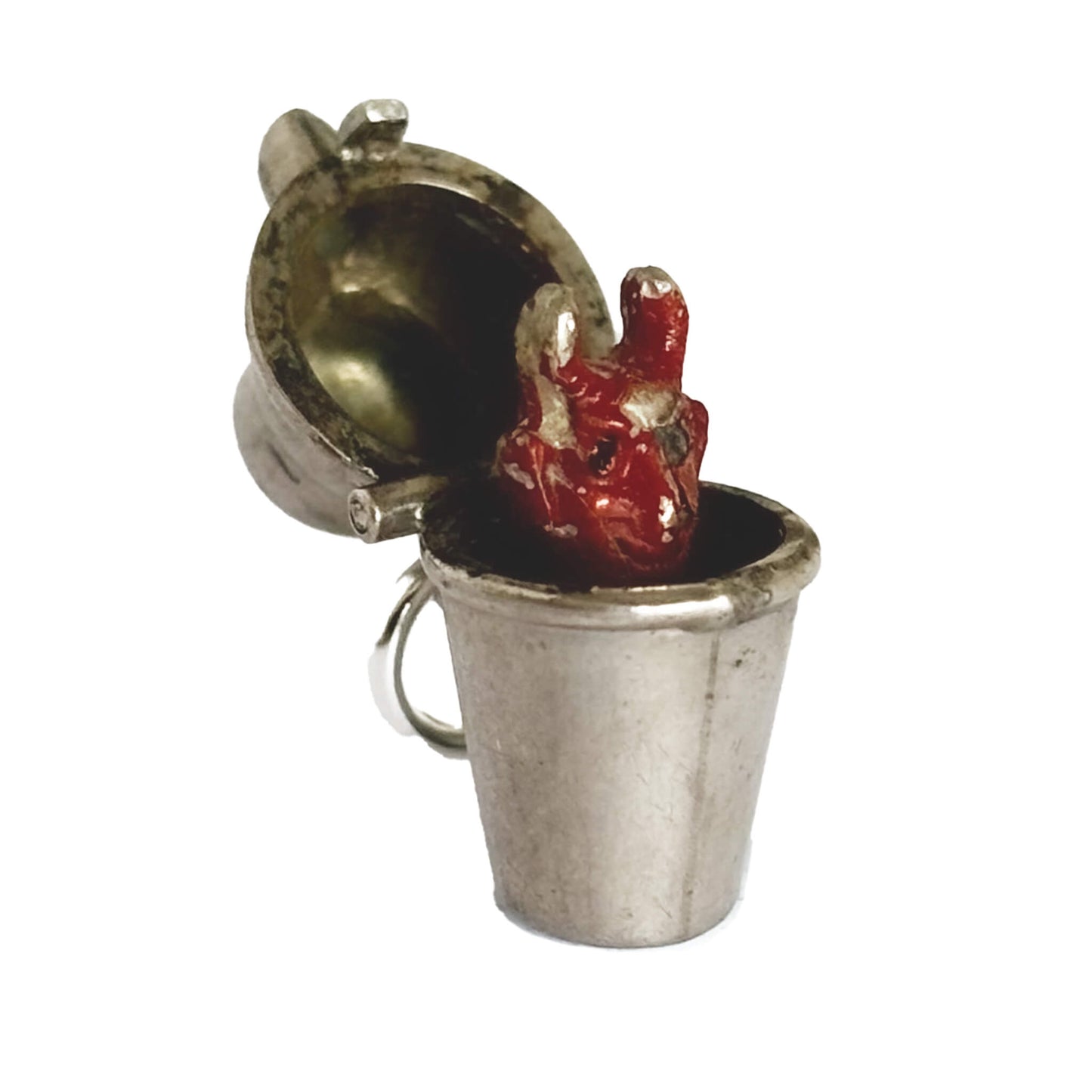 Vintage silver cocktail shaker charm opens to a red enamel devil on a white background