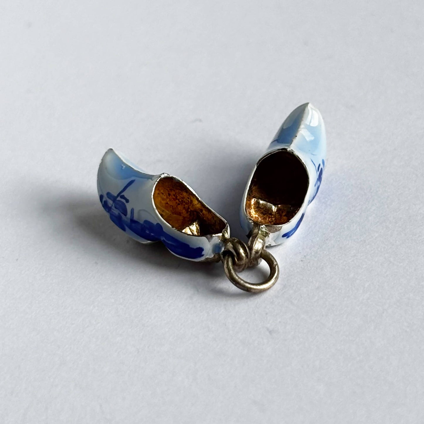 Silver Dutch clogs charm with blue enamel on white background