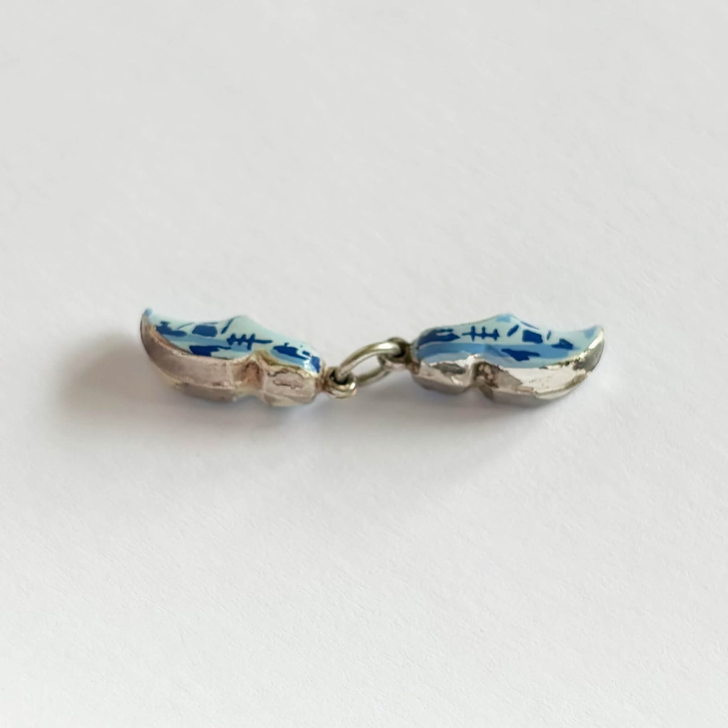 Pair of blue dutch clog shoes charm on a light gray background
