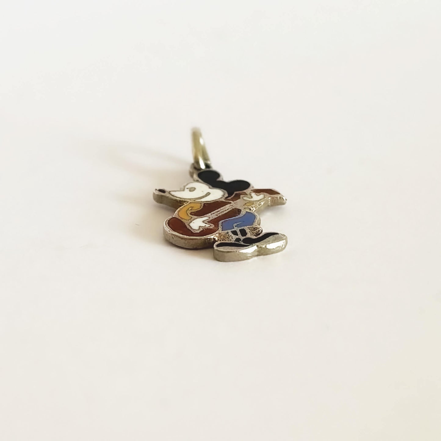 Mouse with guitar pendant on a white background