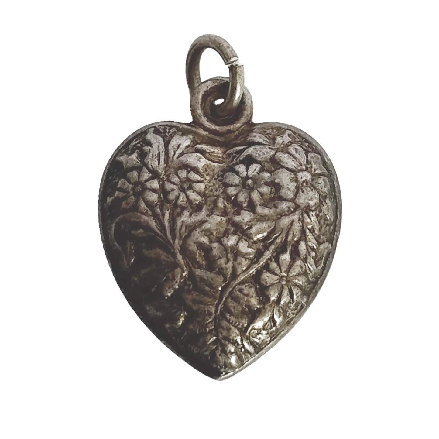 Silver heart-shaped pendant with floral engraving on a white background